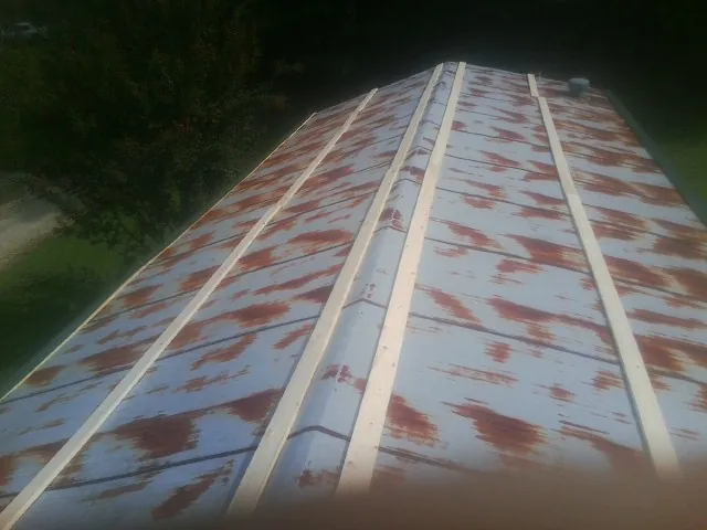Rusted metal roof panels with new wood purlins before replacement — Storm Damage Roof Repair in Hebo by Roofing Brothers