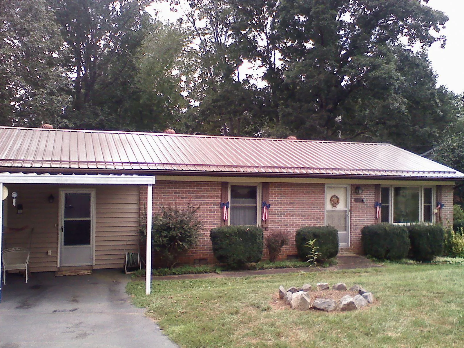 Bronze metal roof and carport on a brick ranch home — Roof Repair work by our crew in Hebo